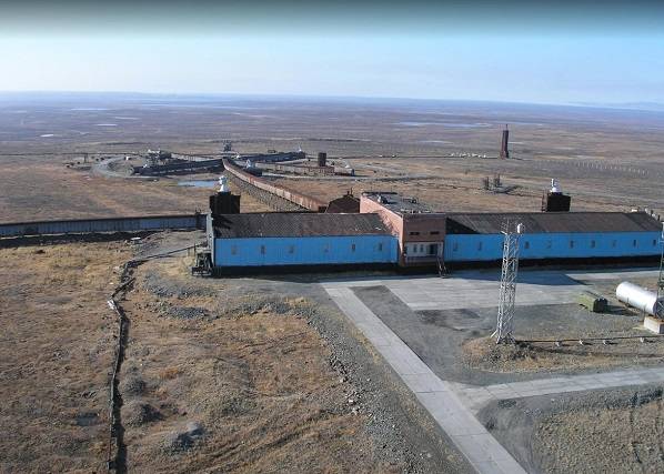 Aerial view of central building and technical position of Vega system in Norilsk with small cross visible in distance