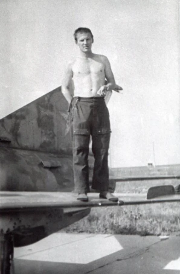 Senior Lieutenant Andrii Nikolaiev performing technical maintenance on MiG-21 fighter jet wing