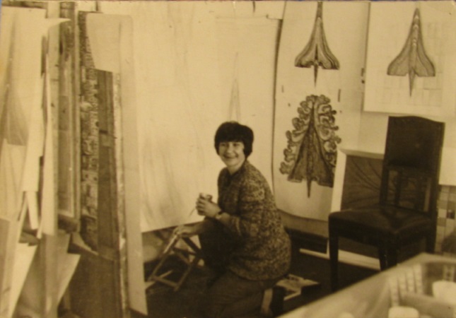 Vera Shevchuk at the design studio desk reviewing sketches
